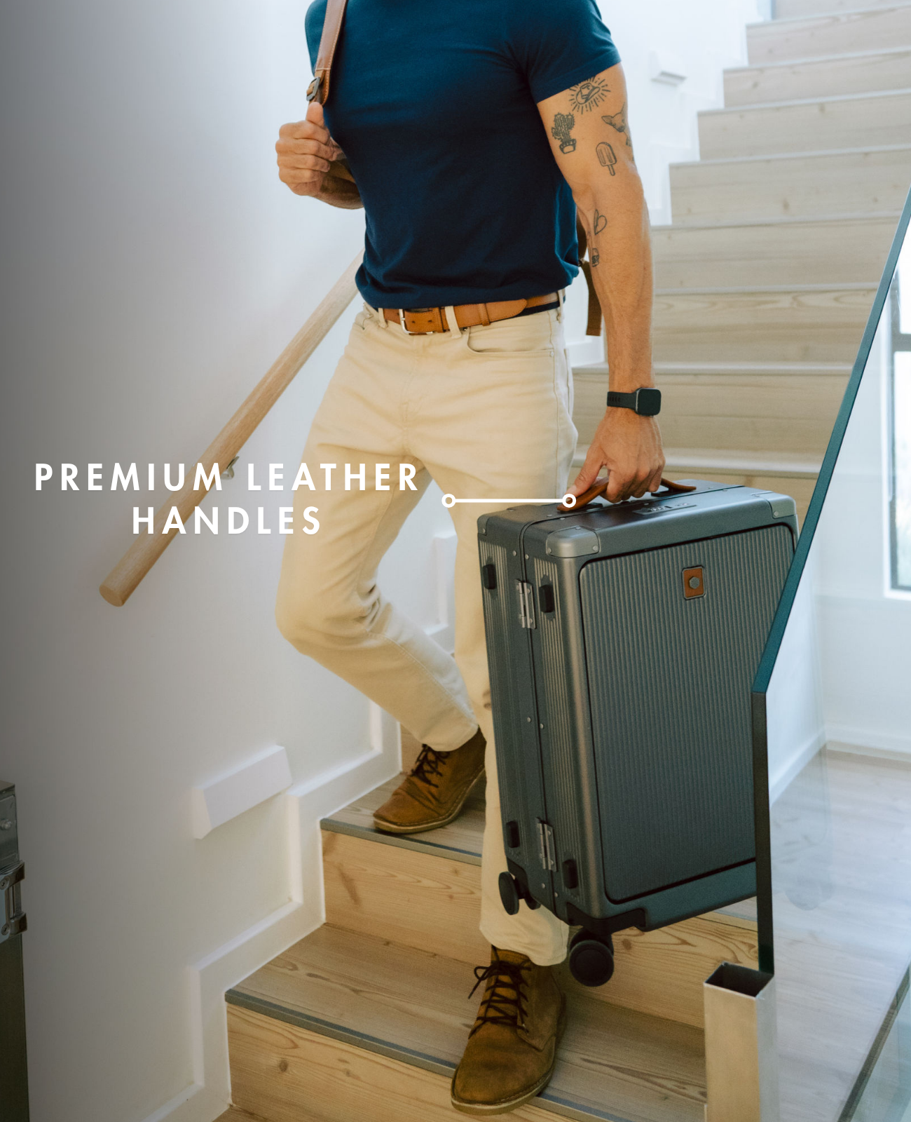 Person with a suitcase and walking stick on a staircase, highlighting premium leather handles.