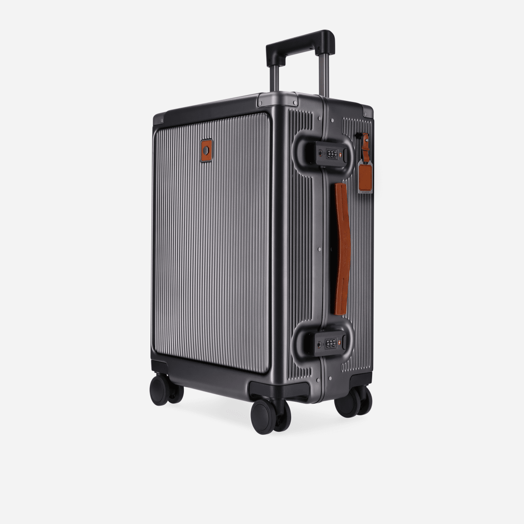 A compact gray cabin trolley suitcase with a front pocket and four wheels.