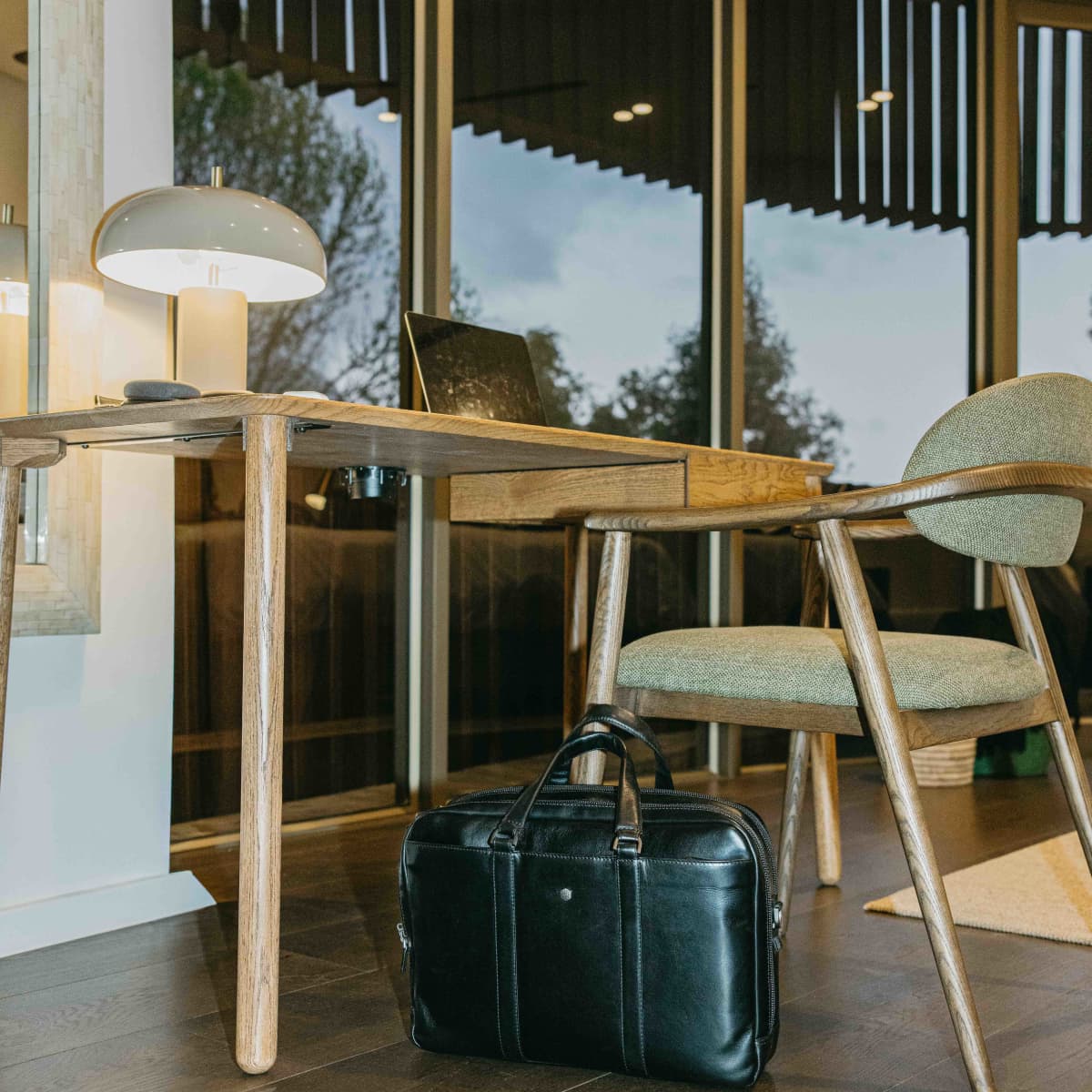 Jekyll and Hide black leather 17 inch laptop briefcase on the floor of a modern office