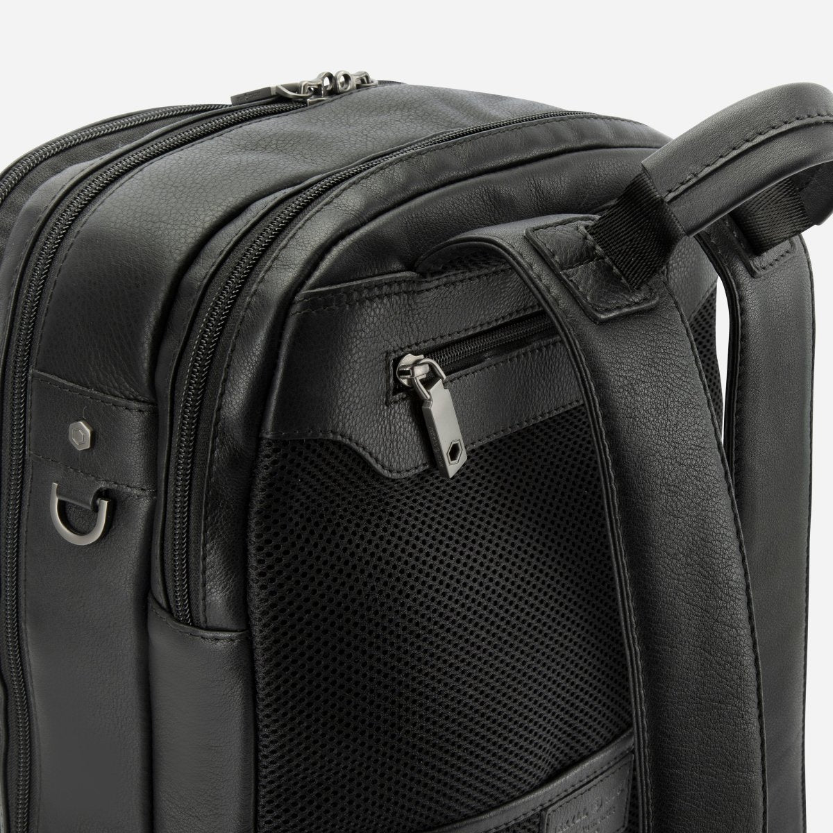 Close-up of the top zips and side mesh pocket on Jekyll and Hide black leather everyday backpack