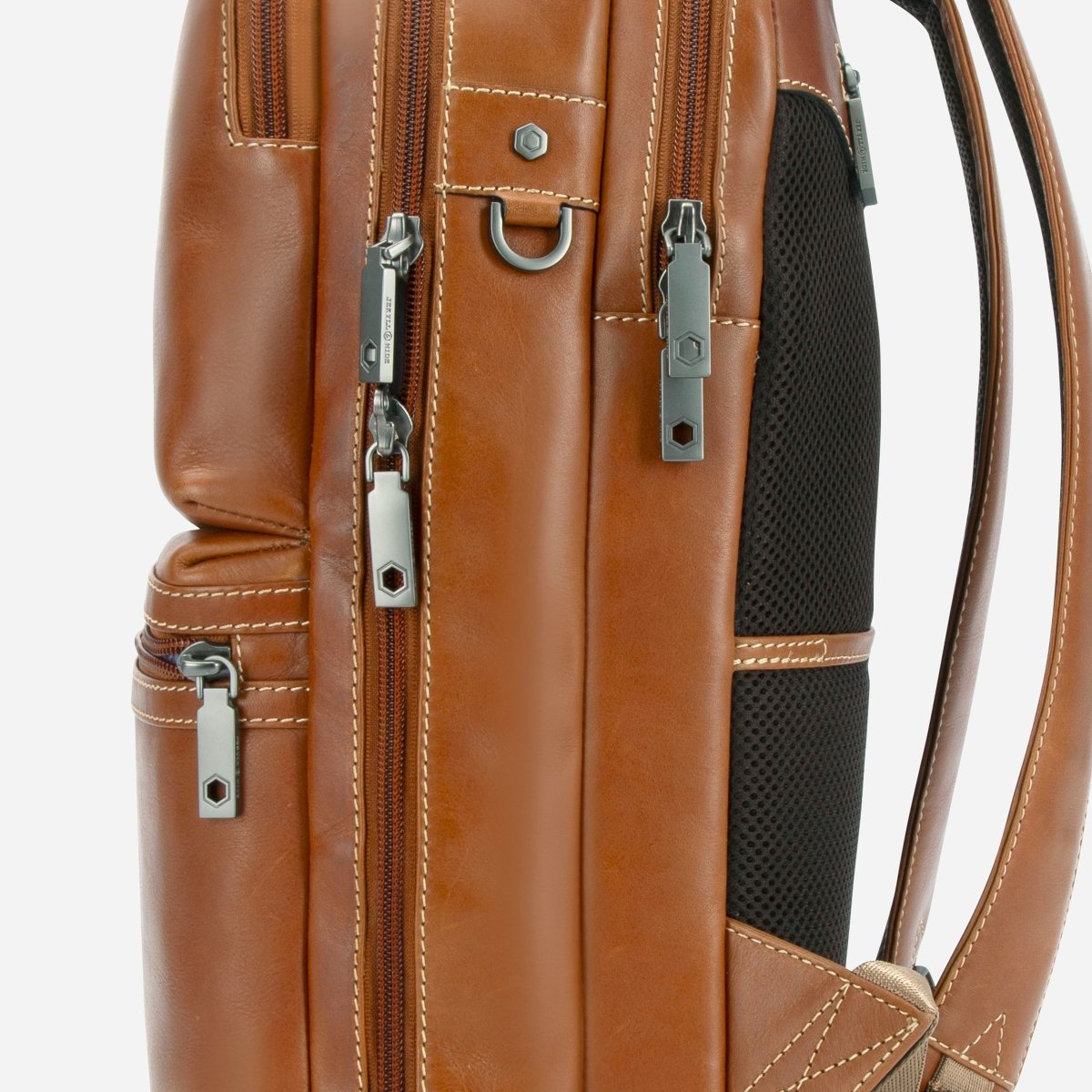 Close-up of the side zips and mesh panel on Jekyll and Hide tan leather everyday backpack