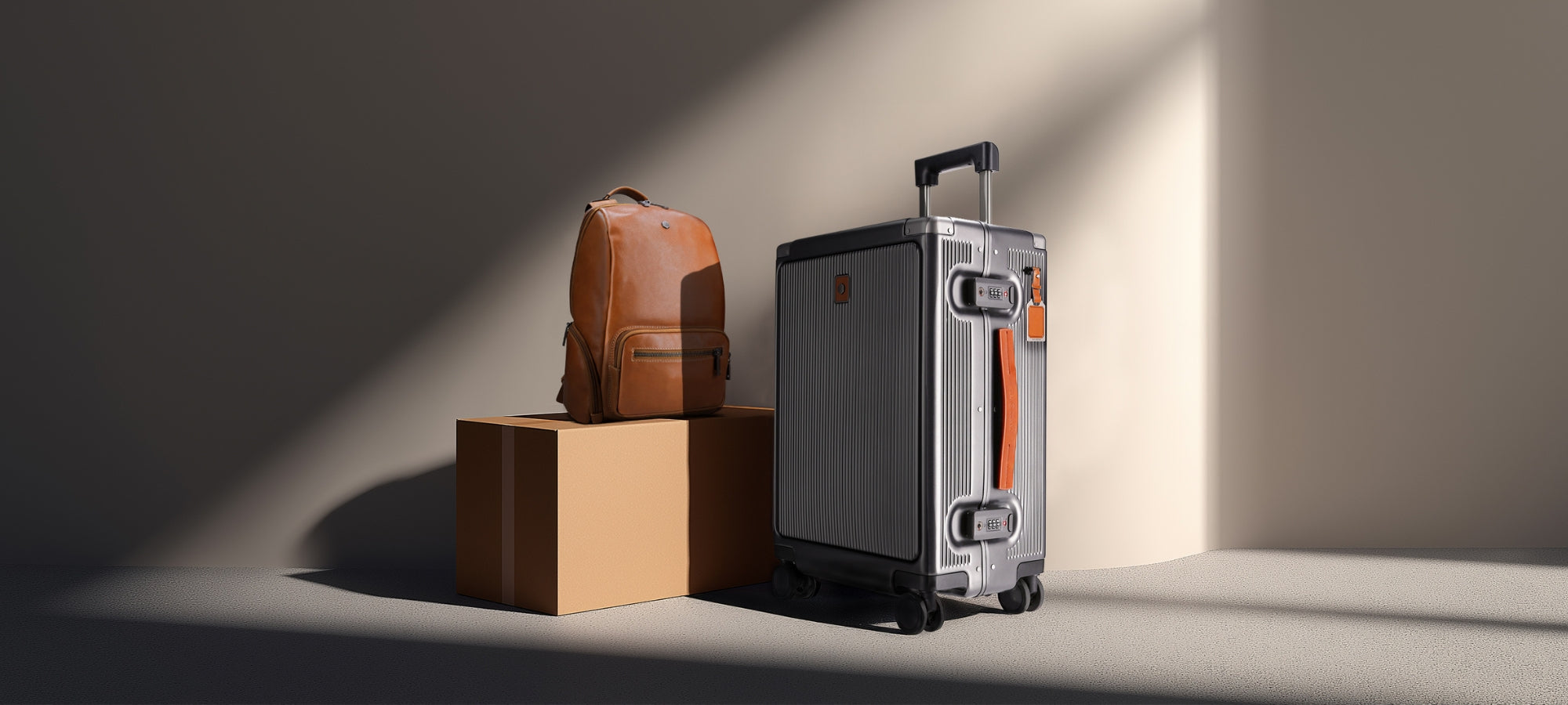 Silver suitcase and brown backpack on a wooden block with soft lighting