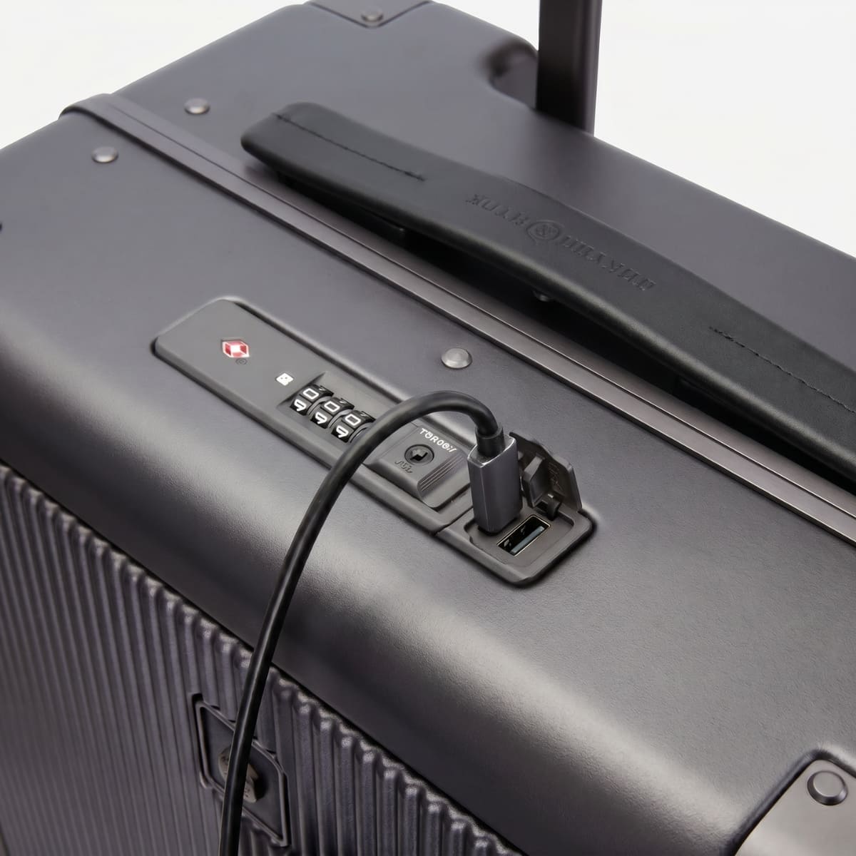 Close-up of a suitcase with charging ports and USB connection on a white background